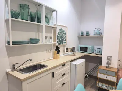 a kitchen with a sink and a microwave at Casa Cervera in San Fernando