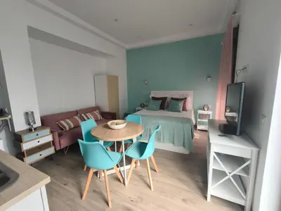 a bedroom with a bed and a table and chairs at Casa Cervera in San Fernando