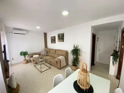 a living room with a couch and a table at Apartamento Malandar in Sanlúcar de Barrameda