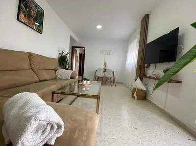 a living room with a couch and a table at Apartamento Malandar in Sanlúcar de Barrameda