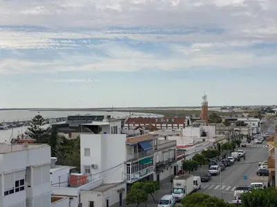 a view of a city with cars parked on a street at Apartamento Malandar in Sanlúcar de Barrameda