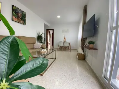 a living room with a couch and a table at Apartamento Malandar in Sanlúcar de Barrameda