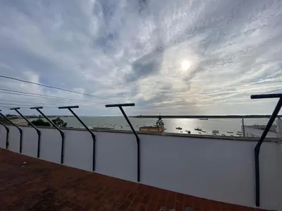 a view of the ocean from a balcony at Apartamento Malandar in Sanlúcar de Barrameda