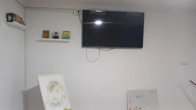 a flat screen tv hanging on a white wall at Casa del Prendi in Jerez de la Frontera