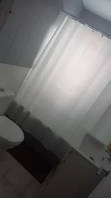 a white bathroom with a white toilet and a light at Casa del Prendi in Jerez de la Frontera