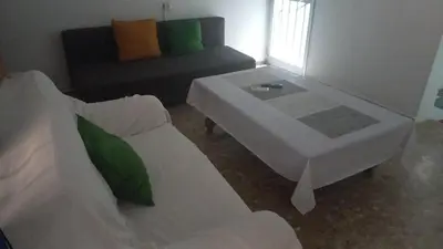 a living room with a white couch and a coffee table at Casa del Prendi in Jerez de la Frontera