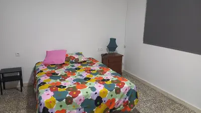 a bedroom with a bed with a colorful comforter at Casa del Prendi in Jerez de la Frontera