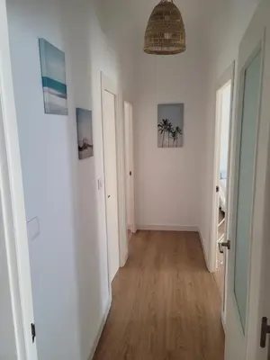 an empty hallway with white walls and wooden floors at Casa Teresa in Sanlúcar de Barrameda