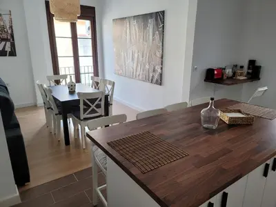 a kitchen and dining room with a table and chairs at Casa Teresa in Sanlúcar de Barrameda