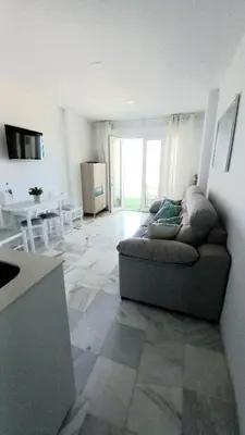 a living room with a couch and a table at La Casa Azul in Chiclana de la Frontera