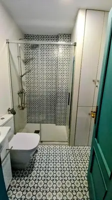 a bathroom with a shower and a toilet and a sink at La Casa Azul in Chiclana de la Frontera