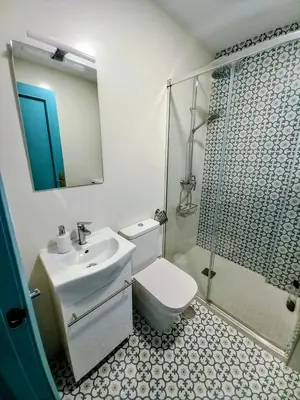 a bathroom with a toilet and a sink and a shower at La Casa Azul in Chiclana de la Frontera