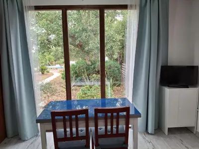 a blue table with two chairs in front of a window at Casa Yuxiao rincón de tranquilidad in Cádiz