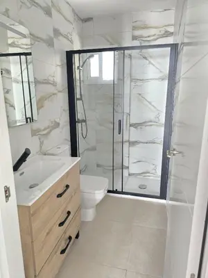 a bathroom with a shower and a toilet and a sink at Piso de la Constitución de 1812 in Cádiz