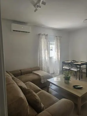 a living room with a couch and a table at Piso de la Constitución de 1812 in Cádiz
