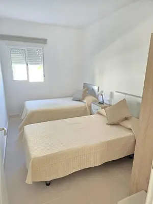 a bedroom with two beds and a window at Piso de la Constitución de 1812 in Cádiz