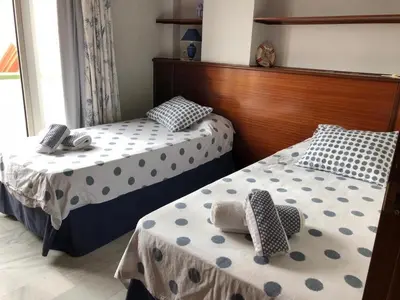 two beds with polka dots on them in a room at Apartamento Playa La Muralla in El Puerto de Santa María