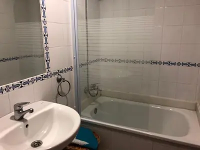 a bathroom with a sink and a bath tub at Apartamento Playa La Muralla in El Puerto de Santa María