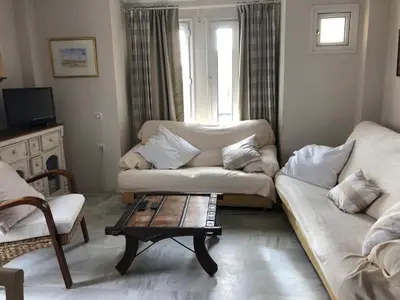 a living room with two couches and a coffee table at Apartamento Playa La Muralla in El Puerto de Santa María