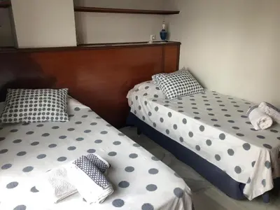 two beds with polka dot pillows in a room at Apartamento Playa La Muralla in El Puerto de Santa María