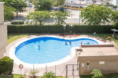 an overhead view of a swimming pool with people in it at Piso de la Manzanilla in Sanlúcar de Barrameda