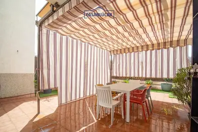 a patio with a table and chairs in a room at Piso de la Manzanilla in Sanlúcar de Barrameda