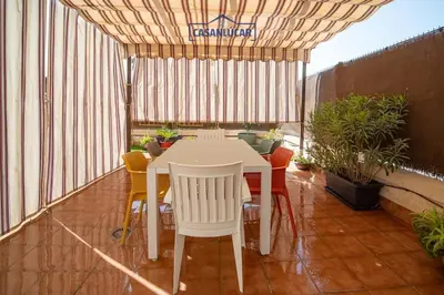 a white table and chairs on a balcony at Piso de la Manzanilla in Sanlúcar de Barrameda