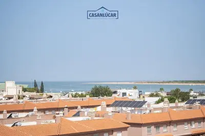 a view of the roofs of buildings in a city at Piso de la Manzanilla in Sanlúcar de Barrameda