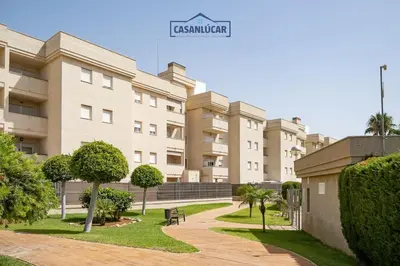 a large building with trees in front of it at Piso de la Manzanilla in Sanlúcar de Barrameda