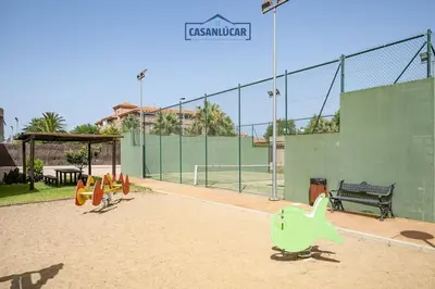 a playground with a toy dinosaur on a tennis court at Piso de la Manzanilla in Sanlúcar de Barrameda