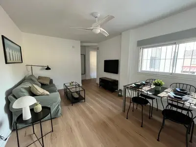 a living room with a couch and a table at Apartamento Pleamar in Sanlúcar de Barrameda