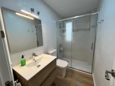 a bathroom with a sink and a shower at Apartamento Pleamar in Sanlúcar de Barrameda