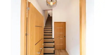 a staircase in a house with a hallway with a stair case at YourHouse Apartamentos Andasol BA in Chipiona
