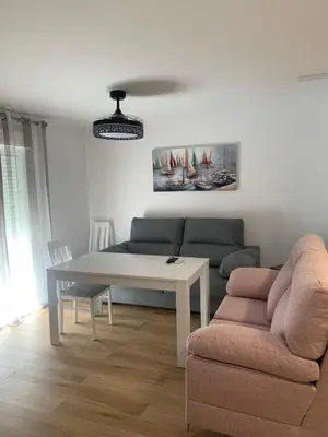 a living room with a couch and a table at YourHouse Apartamentos Andasol BA in Chipiona
