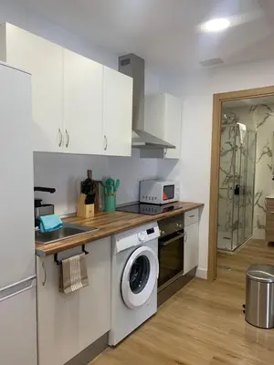 a kitchen with a washer and dryer in it at YourHouse Apartamentos Andasol BA in Chipiona