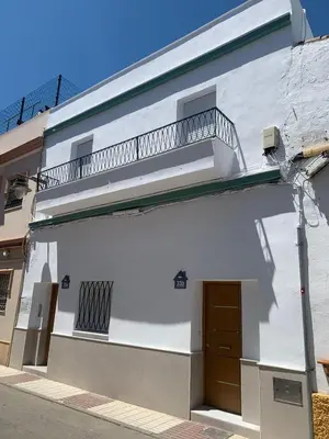 a white building with a balcony on top of it at YourHouse Apartamentos Andasol BA in Chipiona