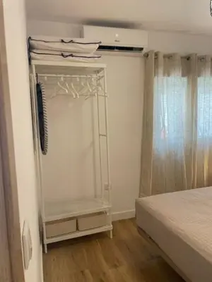 a room with a bedroom with a bed and a closet at YourHouse Apartamentos Andasol BA in Chipiona