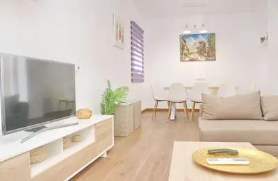 a living room with a large flat screen tv at Alojamiento Rural Las Quintas in Conil de la Frontera