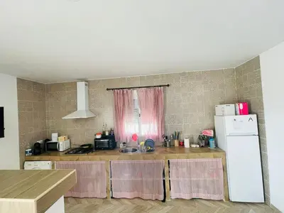 a kitchen with a counter top with a refrigerator at Villa Eterno in Chiclana de la Frontera