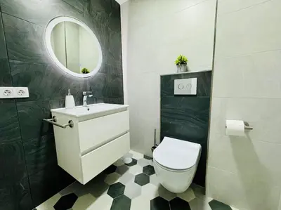 a bathroom with a toilet and a sink and a mirror at El Corner de Esquivel Grupo AC Gestion in Cádiz