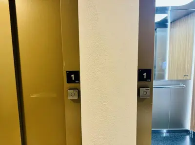 a room with a yellow wall with a refrigerator at El Corner de Esquivel Grupo AC Gestion in Cádiz