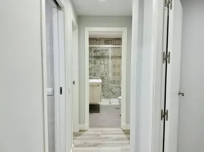 a hallway with a bathroom with a tub and a sink at El Corner de Esquivel Grupo AC Gestion in Cádiz