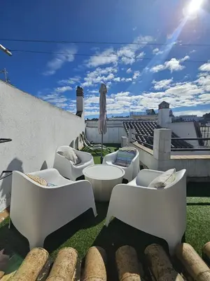a patio with white furniture on a roof at Precioso Ático de Lujo en Calle Ancha in Sanlúcar de Barrameda