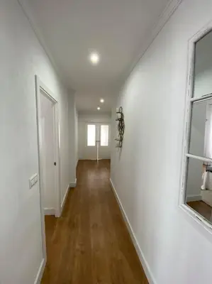 an empty room with white walls and wood floors at Precioso Ático de Lujo en Calle Ancha in Sanlúcar de Barrameda