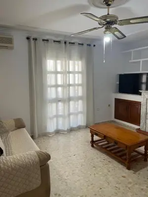 a living room with a couch and a coffee table at Casa MAC in Chiclana de la Frontera