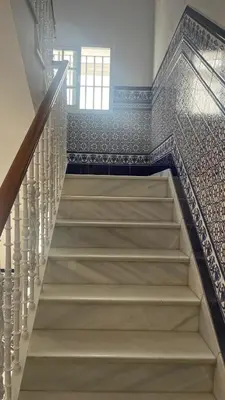 a staircase in a house with blue and white tiles at Casa MAC in Chiclana de la Frontera