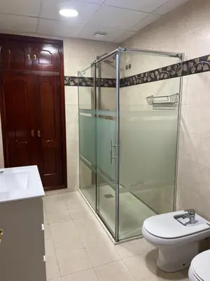 a bathroom with a glass shower and a toilet at Casa MAC in Chiclana de la Frontera