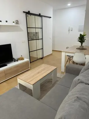 a living room with a couch and a table at Piso Centro Chiclana in Chiclana de la Frontera
