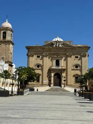 a large brick building with a clock tower on top at Piso Centro Chiclana in Chiclana de la Frontera
