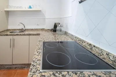 a kitchen with a sink and a counter top at Kotinousa Cádiz - Centro historico in Cádiz